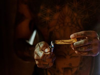 Incense smoke and a candle in a peaceful room.